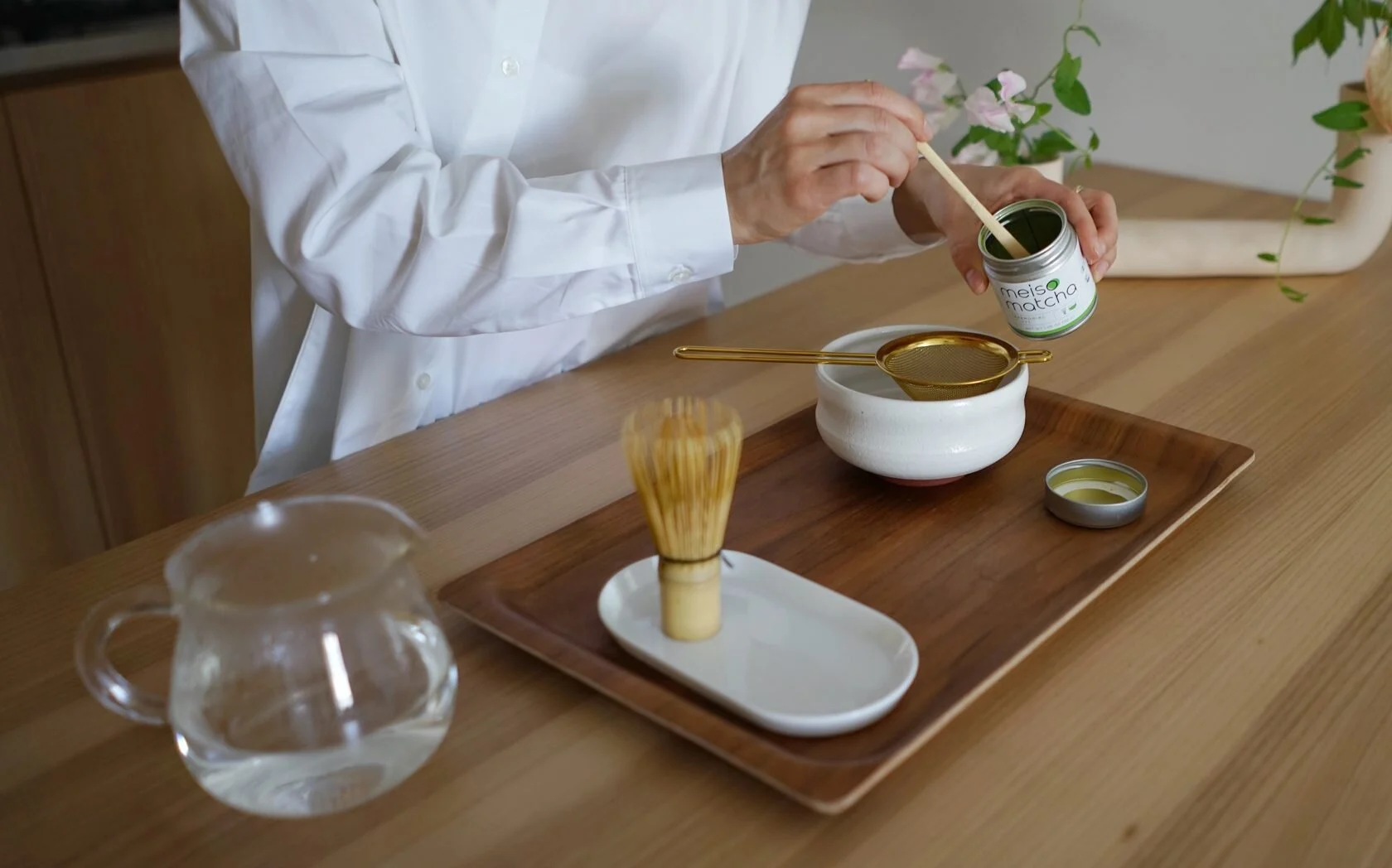 Matcha ceremony with whisk, bowl and wooden tray