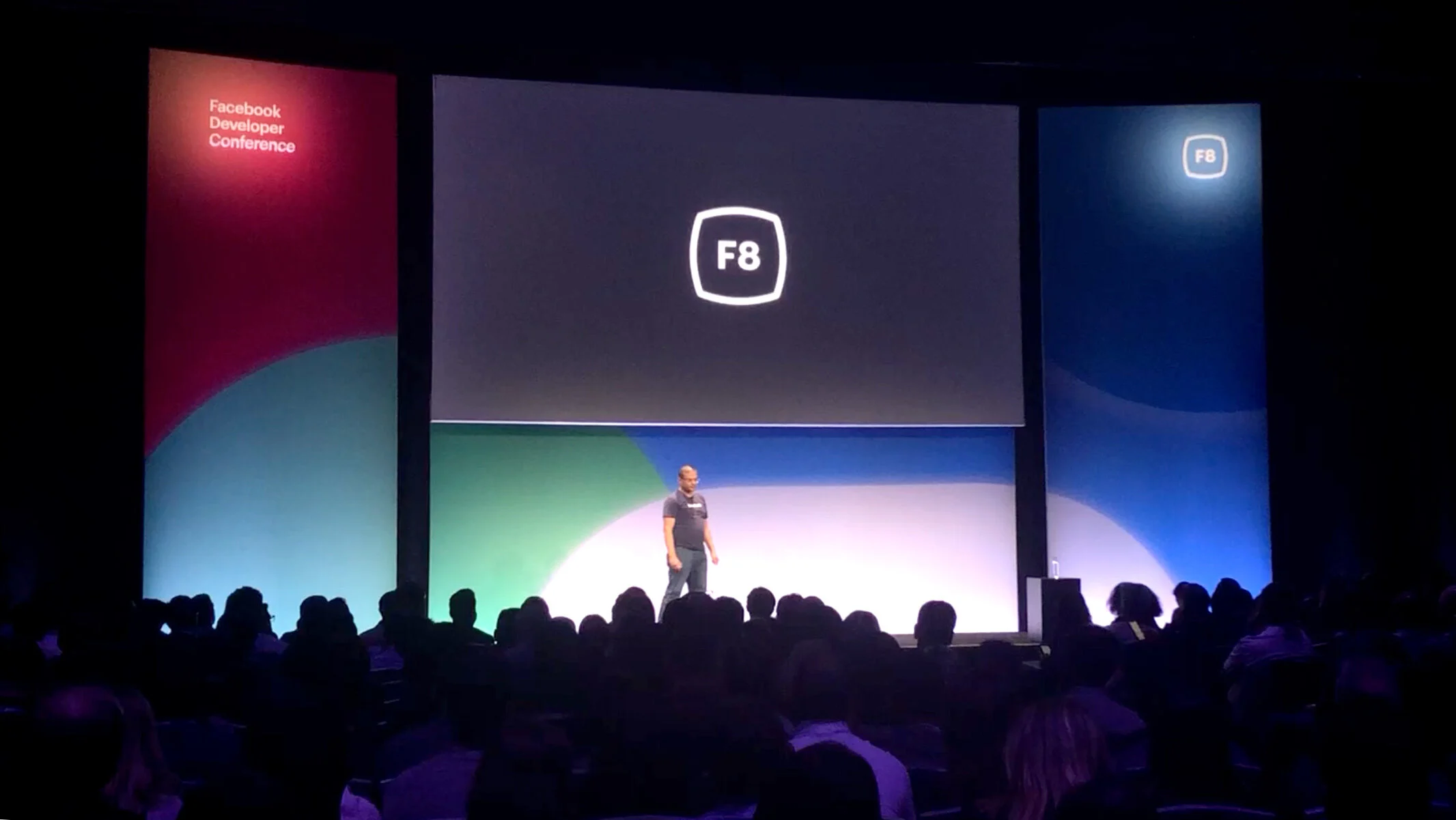 Wide shot of the F8 mainstage with three screens